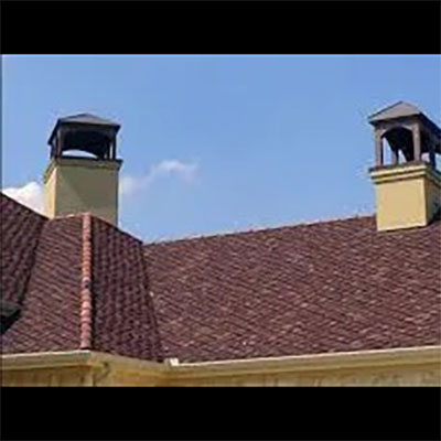 Stock photo of custom chimney caps - West Tennessee Chimneys Custom chimney caps on two different chimneys on slate roof