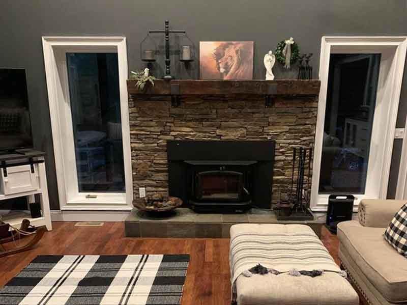 Beautiful rock fireplace surround with stove insert and windows on each side - West Tennessee Chimney