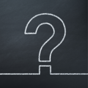 a well-drawn chalk question mark outline on a black chalkboard